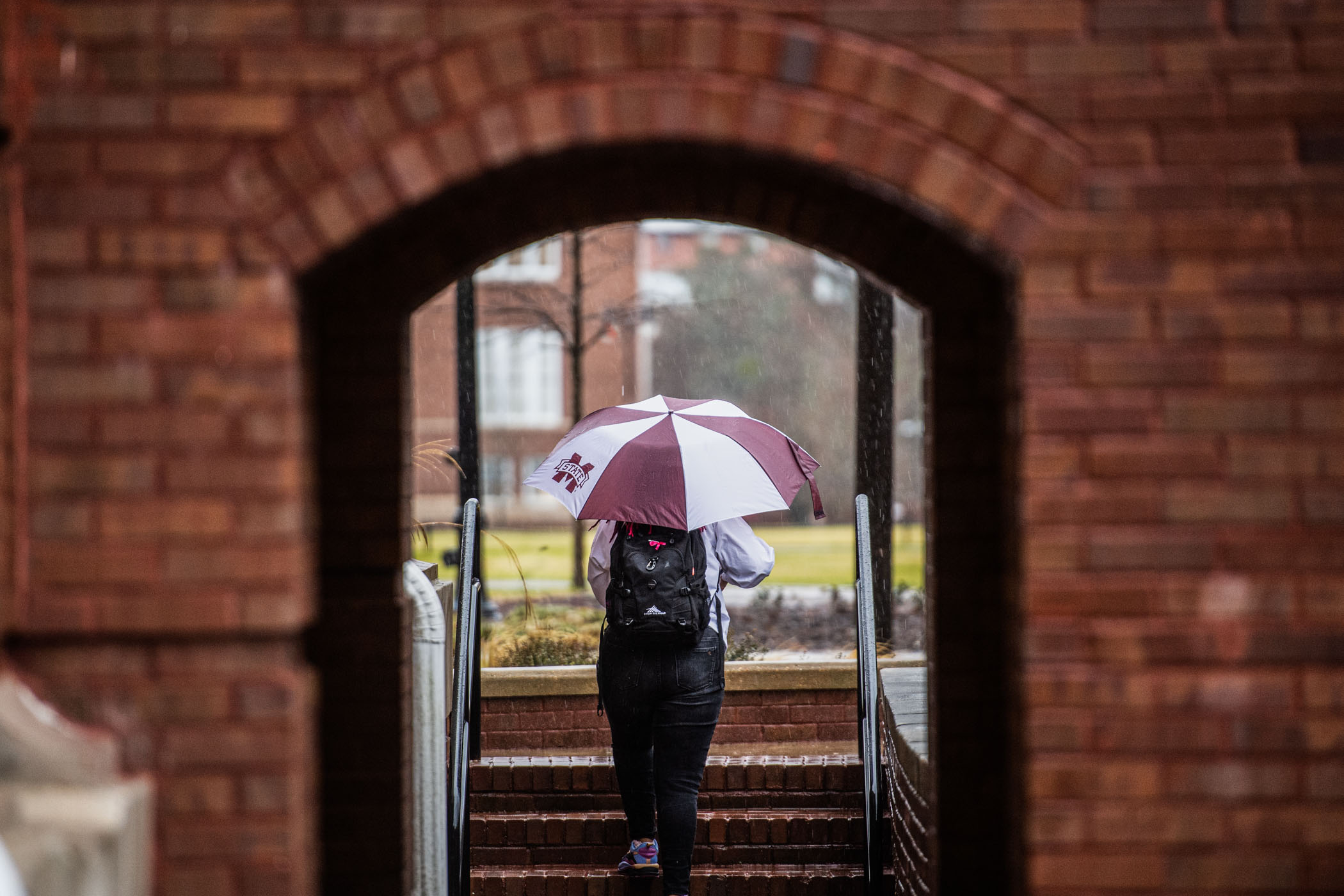 Resilient student braves the rain to get to class.
