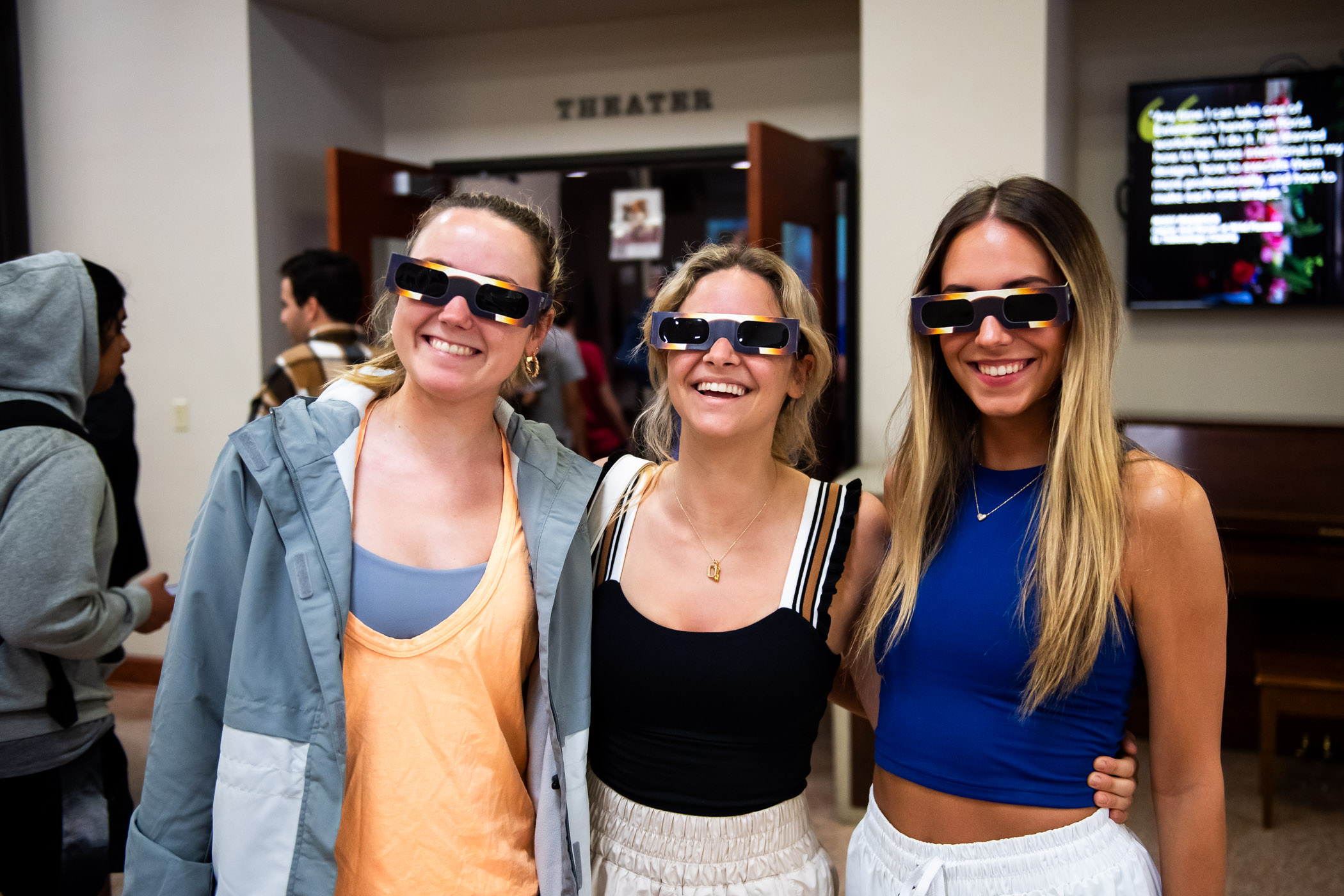 Claire Dillard (left,) Ella Hahs, (center,) and Elise Edwards (right,) sport their safety glasses at ֱ&#039;s live viewing of the 2024 Great American Solar Eclipse inside Bost Theate