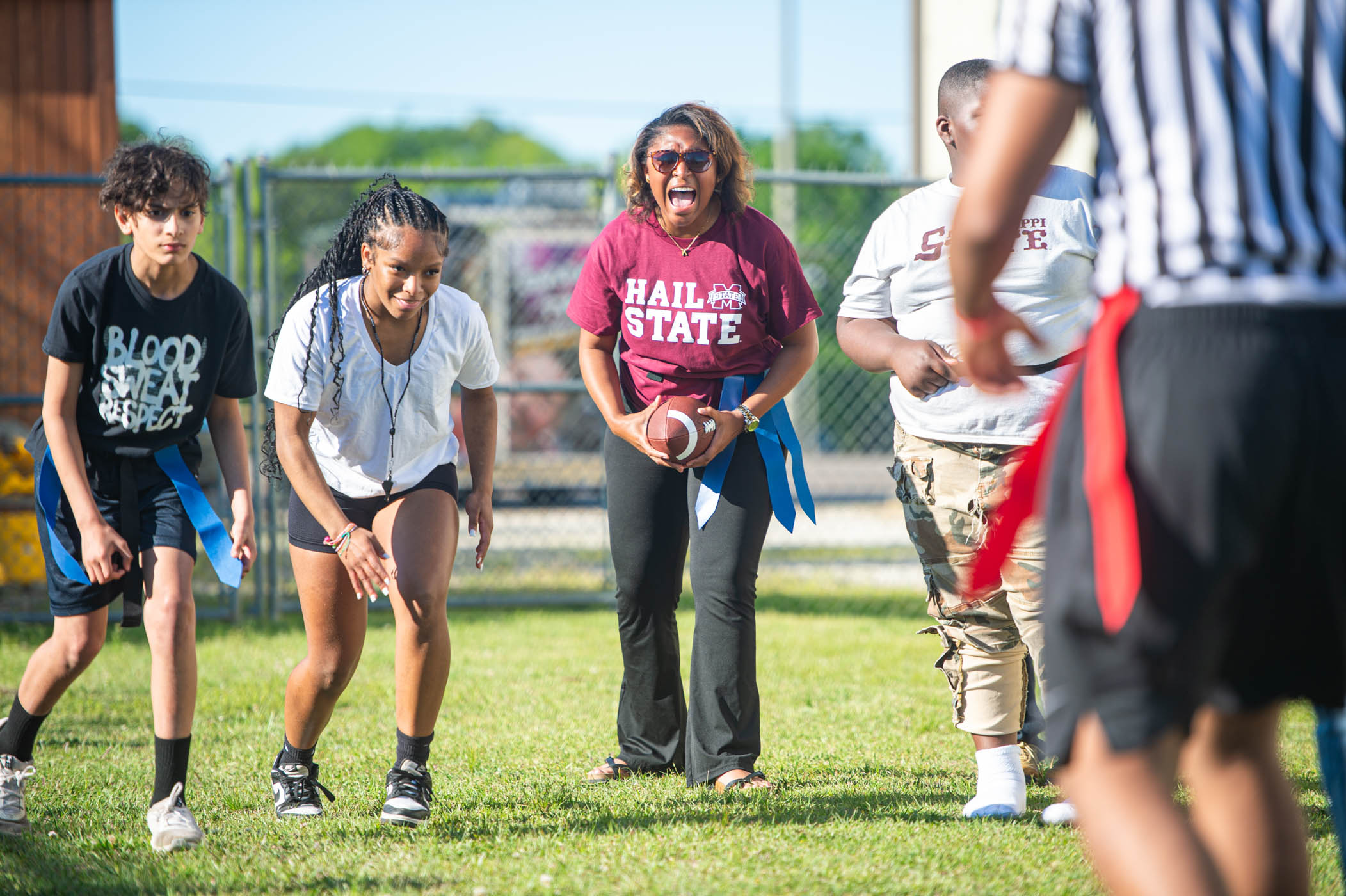 Students in ֱ’s Montgomery Leadership Program play a game of flag football with youth at the Boys &amp; Girls Club of the Golden Triangle